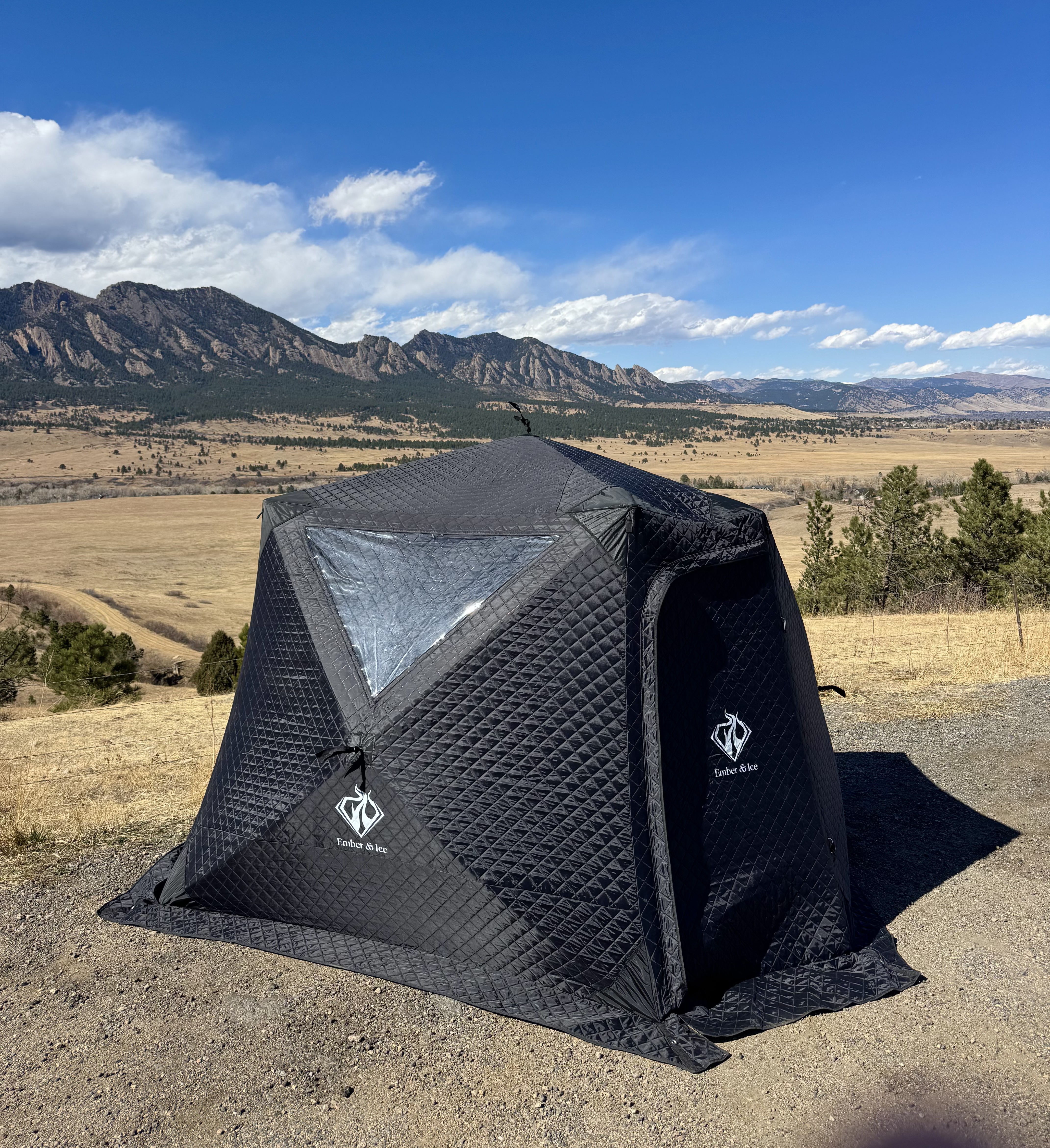 Ember & Ice sauna tent with Boulder Flatirons behind it